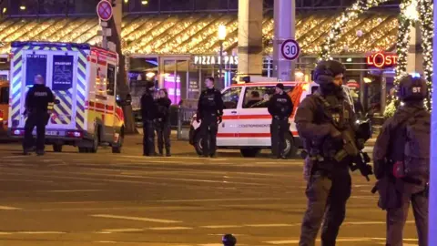 Getty Images Police and ambulances stand next to the Christmas market in Magdeburg