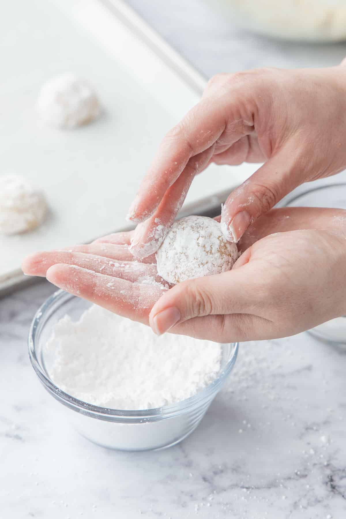 Shaping cookie dough into an even ball.