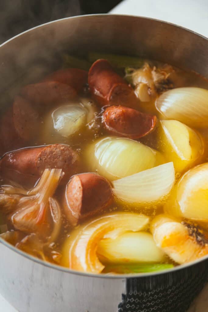 Shrimp boil recipe simmering in large stock pot.