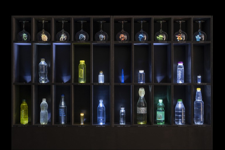 An art Installation with shelves containing contaminated water samples collected and sent in by contributors.