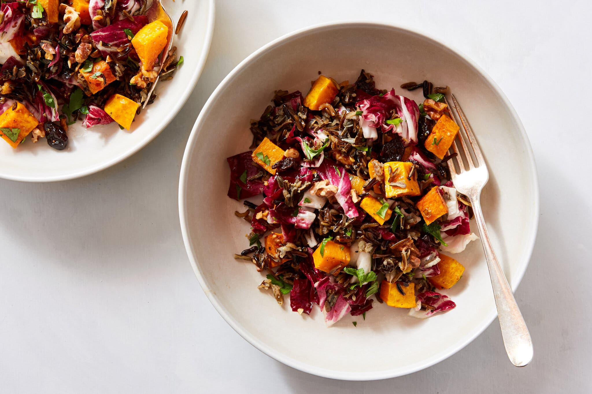 An overhead image of butternut squash topping a radicchio salad.