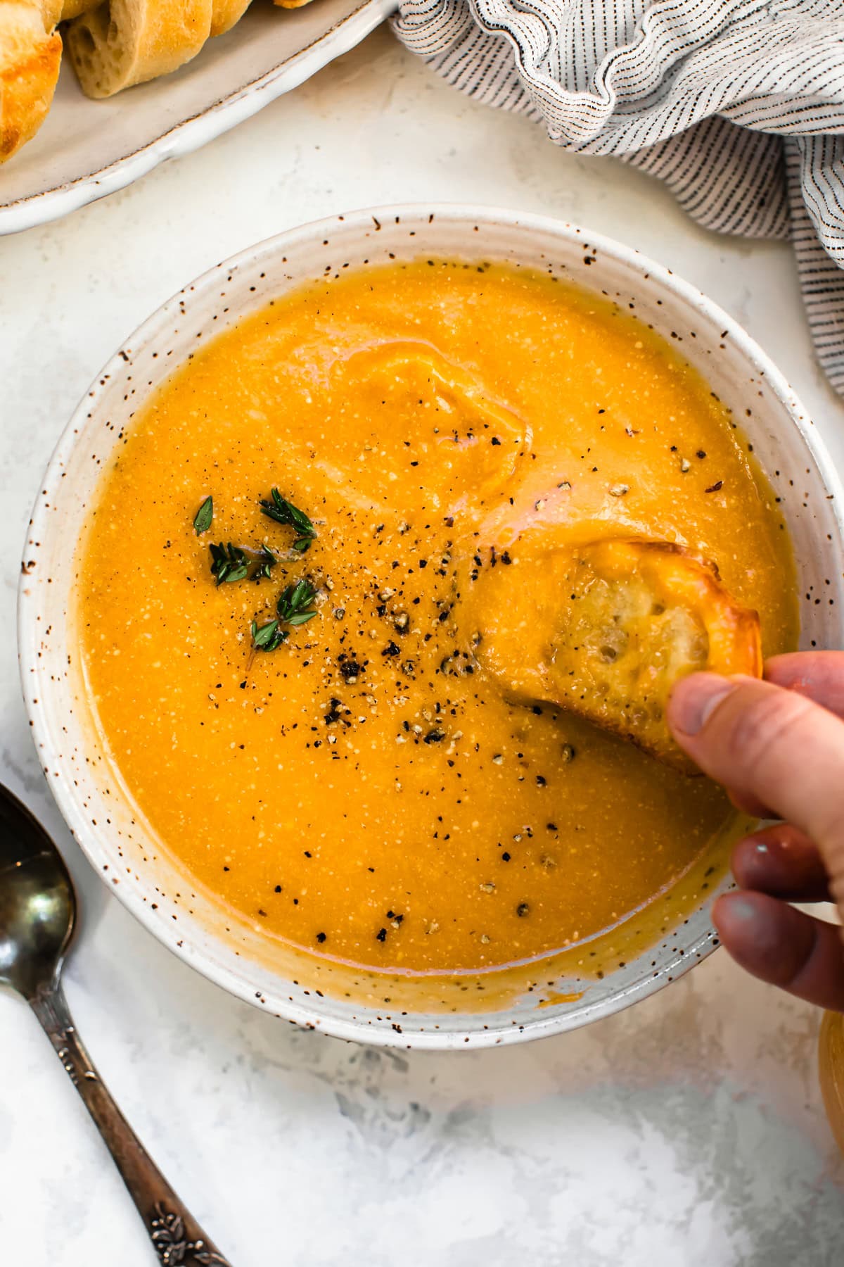 Butternut Squash Cheddar Soup in a bowl with bread